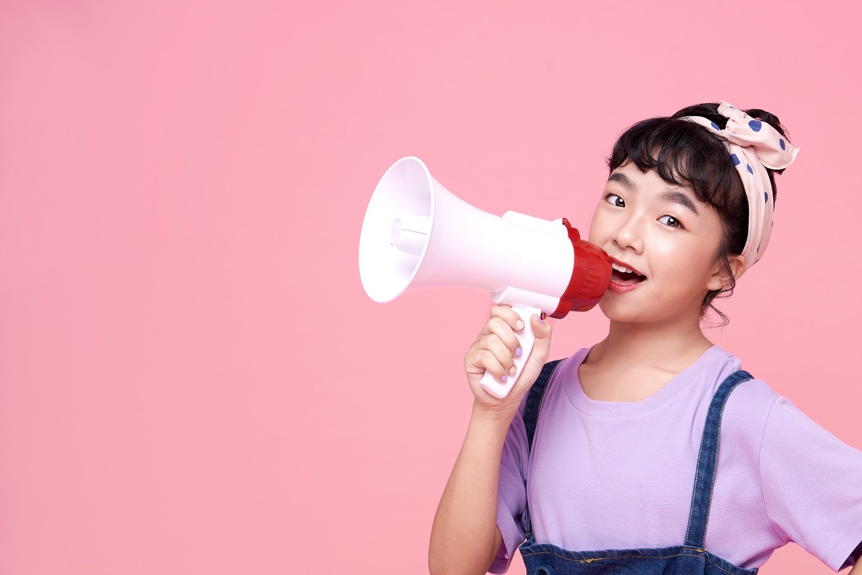A girl with a megaphone, symbolising 'getting mouthy' about head and neck cancers